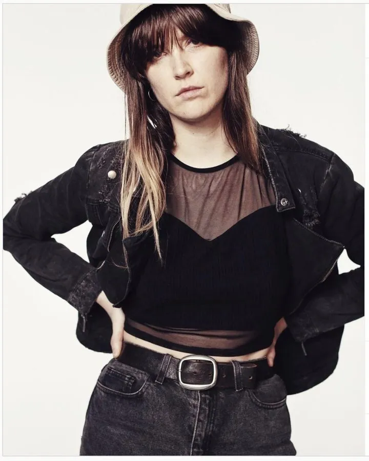 Marguerite Lorraine in a bucket hat and black denim jacket
